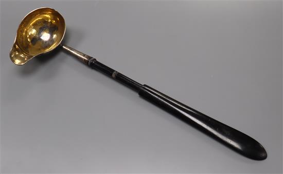 An antique German parcel gilt silver punch ladle, with ebonised handle